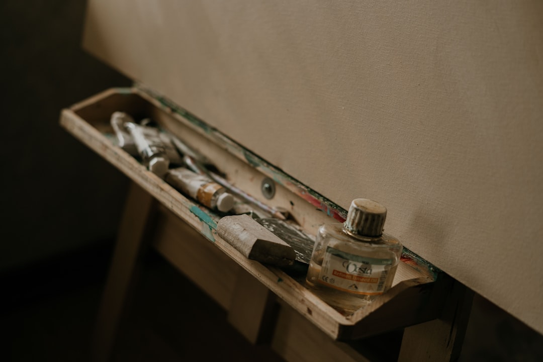 Art supplies on an easel with blank canvas