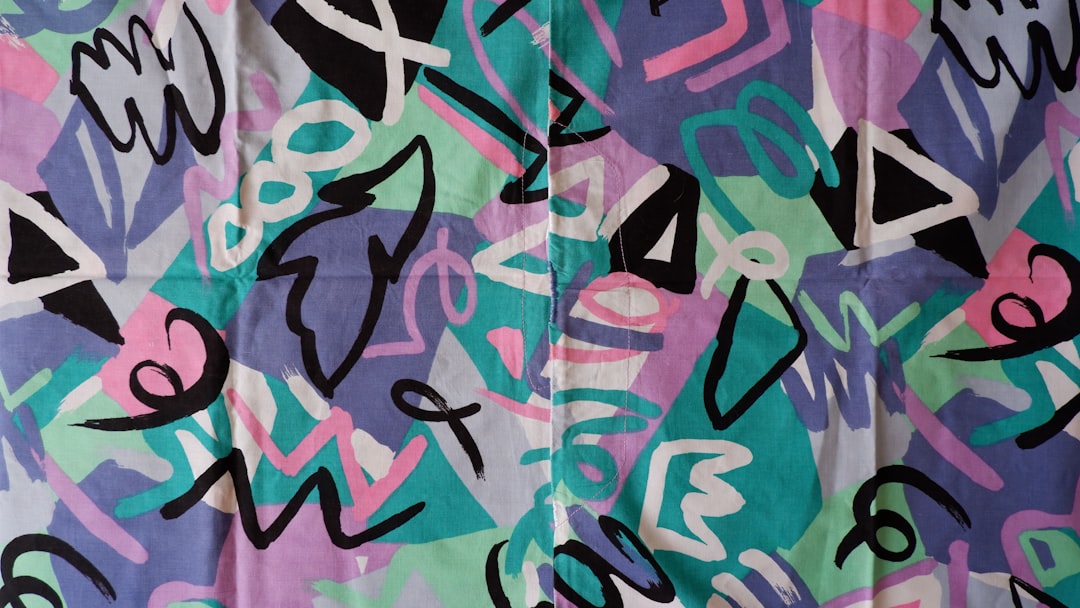 a multicolored pattern of letters and numbers on a sheet