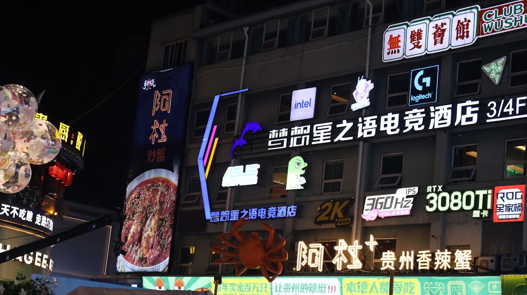 Bright neon signs illuminate a building at night.