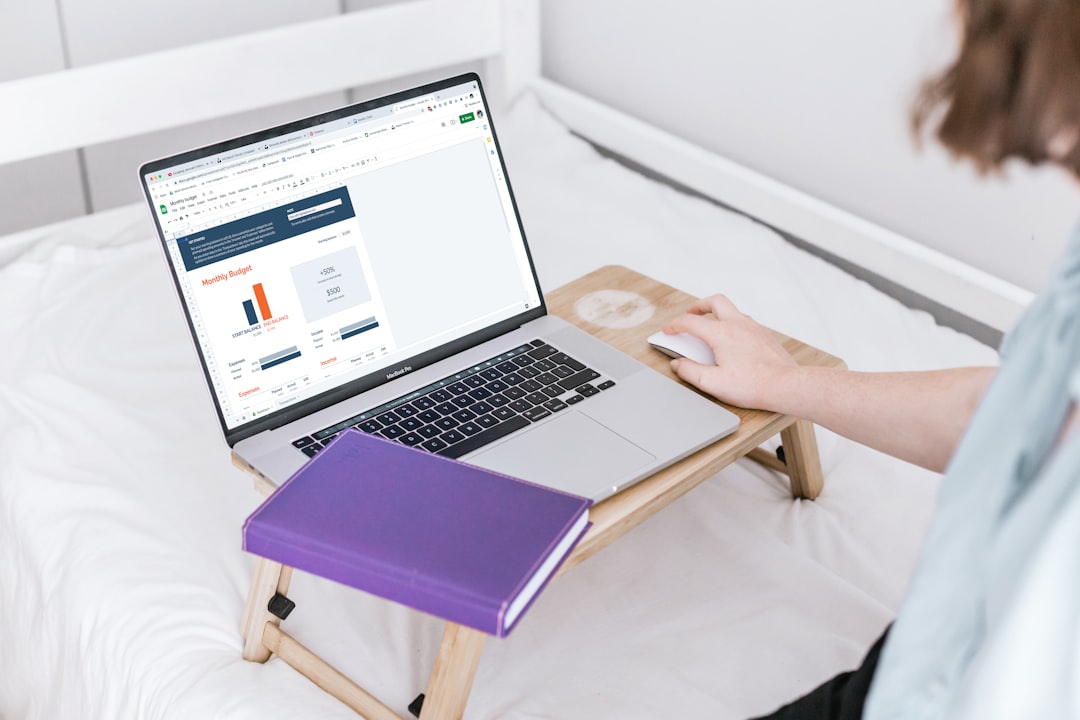 a person using a laptop on a bed