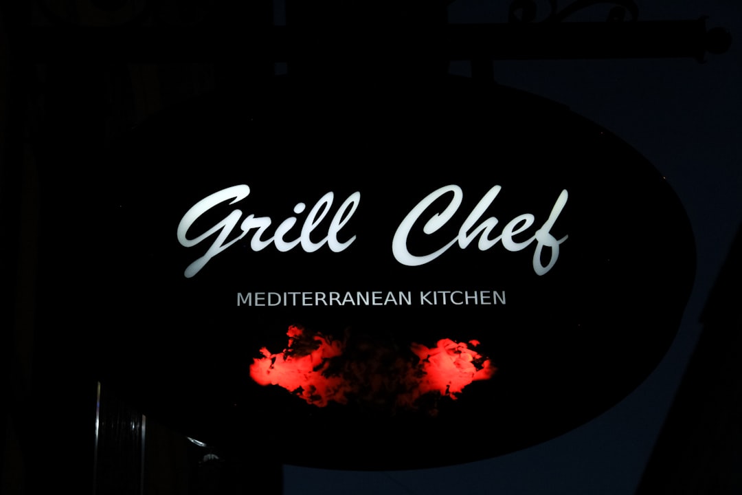 a sign for a restaurant that is lit up at night