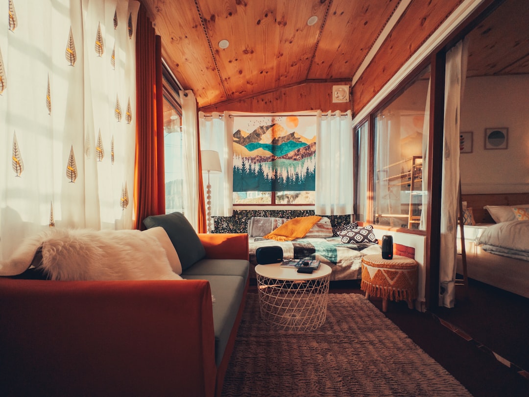 Cozy living room with mountain tapestry and large windows